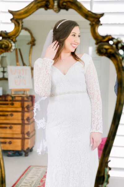 Bride takes a portrait in the mirror