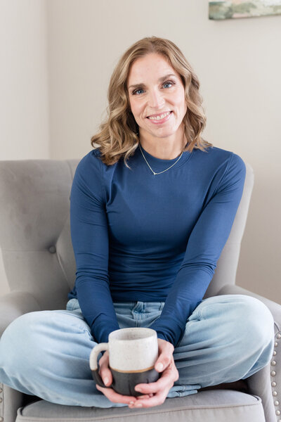 Stephanie sitting in a chair smiling