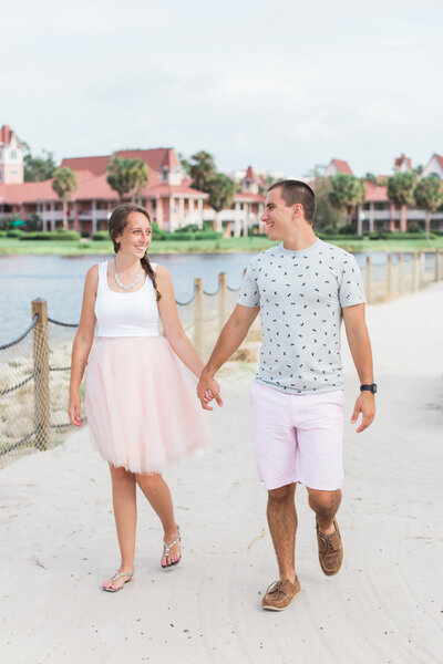 Couple holding hands and walking at Disney