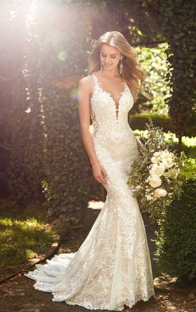 BREATHTAKING GARDEN LACE WEDDING DRESS Inspired by a breathtaking floral garden, this lace wedding dress from Martina Liana is completely elegant and romantic. Organic lace adorns the bodice of this gown in the most effortless way, edging the straps and plunging V-neckline perfectly. Large, lace motifs highlight the bodice of this gown, and extend through the layered lace skirt, creating a true floral explosion. Sheer side cutouts are placed on either side of the bodice, highlighted with coordinating floral lace details. Illusion tulle and lace create a plunging V on the back of this gown, complete with buttons running down the center. Beading and sequin lace give this gown an all-over, sophisticated sparkle that is undeniably beautiful. The back of this lace wedding dress zips up beneath pearl buttons.