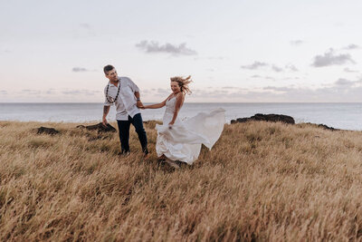 Hawaii Destination Wedding Photographer captures bride and groom on cliff after Hawaii beach wedding