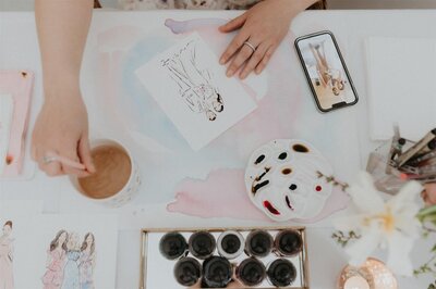 Close-up of Stephanie Anne Illustration's watercolor art supplies and live sketching materials during a in person event
