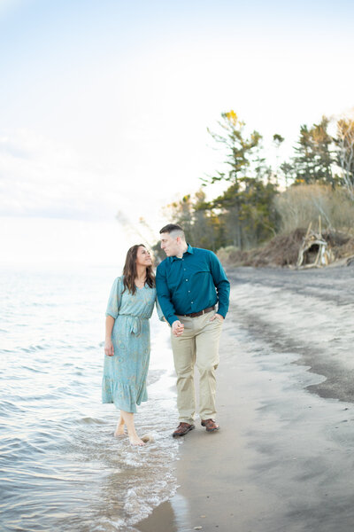 Couple walks along the beach during their Wisconsin photo session.