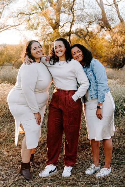 three sister pose outdoors