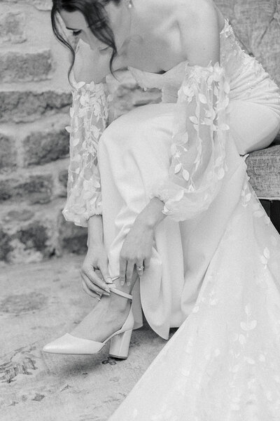 Bride putting on heels while getting ready for her Ottawa wedding