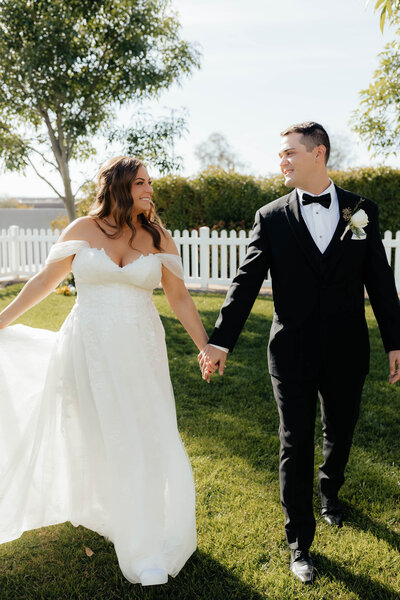 Bride and groom walk holding hands at hope barn Phoenix