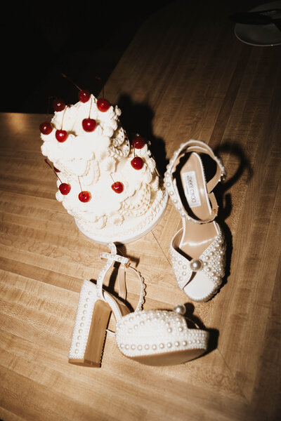 flash wedding photography of a vintage wedding cake and the bride's heels