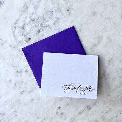 Card that reads "thank you" in cursive script