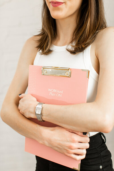 Founder holding pink clip board - Clic