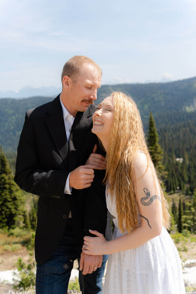couple snuggling and holding hands after their elopement