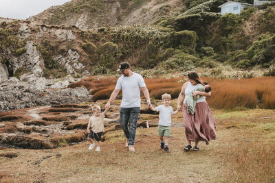 Chantal Hewitt holding her daughter and walking hand in hand with her two sons and her husband in nature  - Family Autism Support Coach at Chantal Hewitt Coaching15