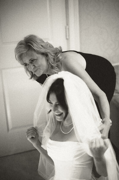 Blonde bride with a lacy long sleeve wedding dress holding bouquet