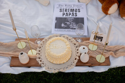 Man and woman holding up a baby onesie to celebrate pregnancy