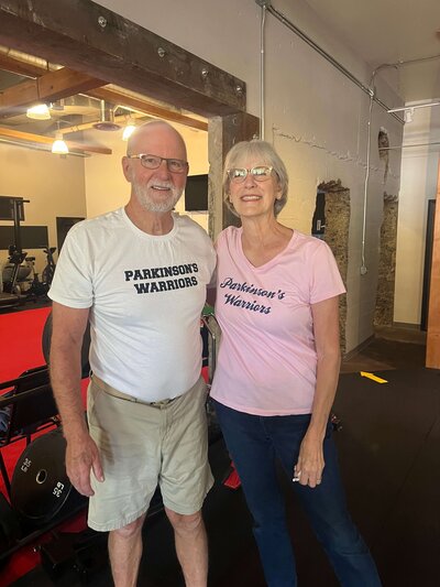 Two Parkinson's Warriors smile in the former Parkinson's gym in Eugene.