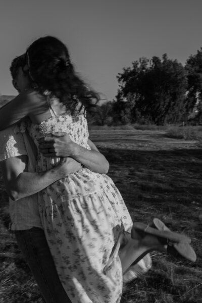 David picking up and twirling Elizabeth, in black and white.
