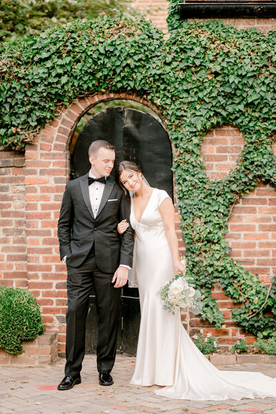 Couple standing in front of door during wedding portraits in Richmond Virginia
