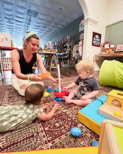 Women playing with babies on the floor