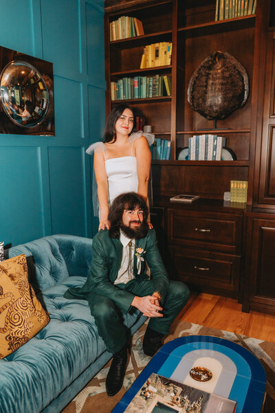Newlyweds pose on a couch