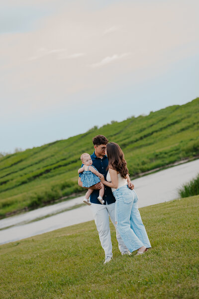 Outdoor family photoshoot in Omaha park during golden hour – capturing candid, heartfelt moments.
