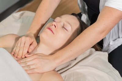 Devon Denys performing a manual lymphatic drainage massage, a specialized therapeutic technique in Colorado.