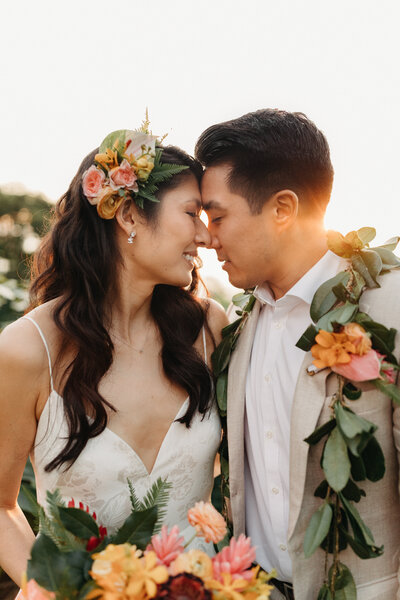 Bride and groom sharing a romantic snuggle at sunset at Holualoa Inn on the Big Island of Hawaii, Kailua Kona
