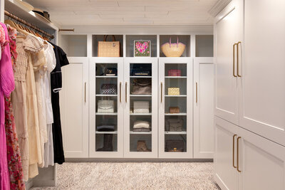 Custom closet design with cabinetry and shelving designed by Zimmer Interiors.