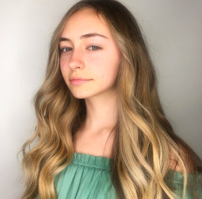 Image of client with dark blonde full highlights.