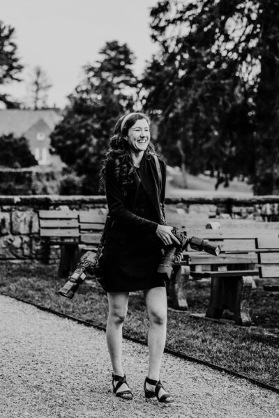 black and white image of massachusetts wedding photographer meghan lynch smiling during a turner hill mansion wedding