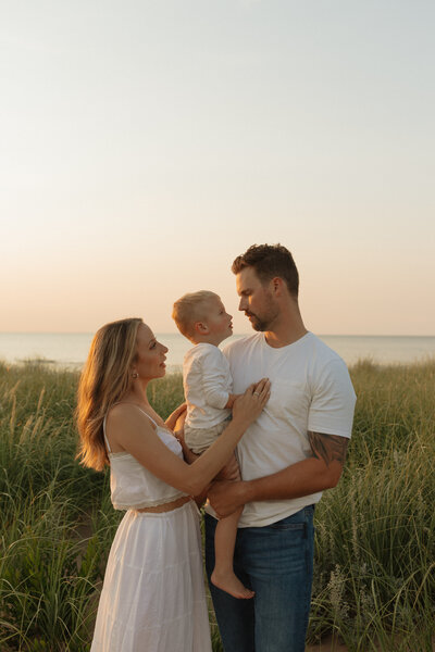 family posing for lifestyle photos on beach prince edward island