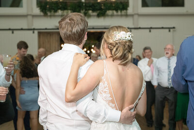 Bride and groom embrace during their wedding reception