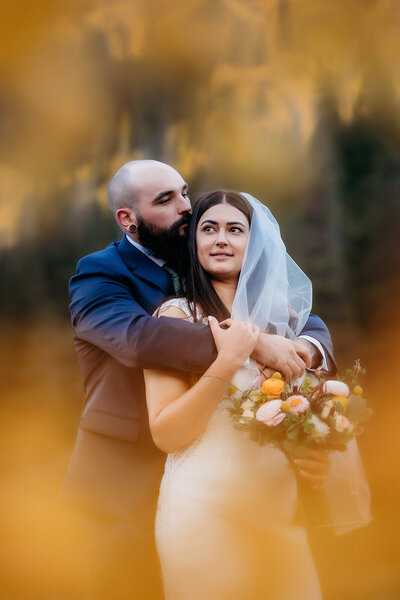 Colorado Elopement Photographer captures bride leaning against groom during bridal portraits