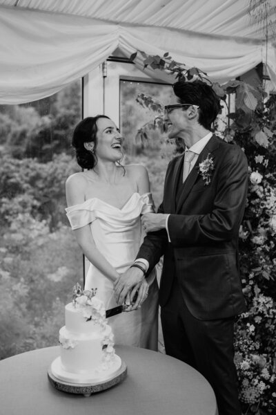 A wide overheard view of a wedding couple as they wrap their arms around each other in David Welch Winter Gardens in Aberdeen. They are surrounded by cacti in a botanical glasshouse.