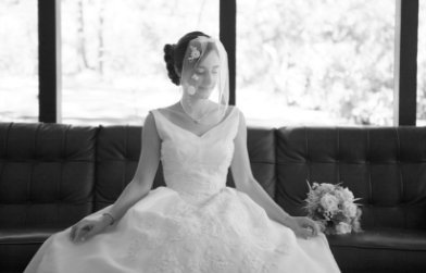 Grass Valley Wedding Fair bride sitting on leather couch before wedding at venue The Roth Estate Nevada City, Joy of Life Events wedding planner