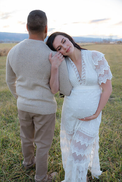 Pregnant woman in a red maternity dress and a floral crown.