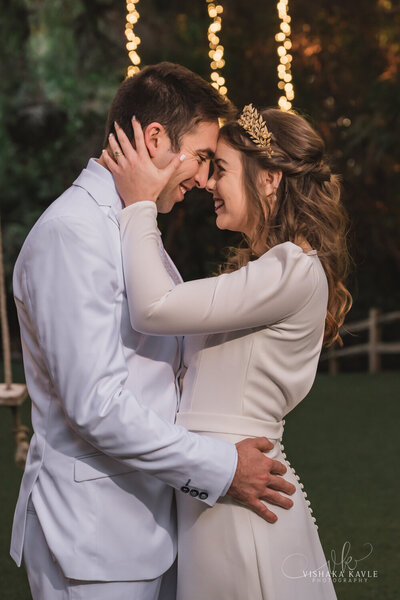 bride and groom smiling and embracing