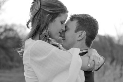 Groom picking up Bride, faces close together