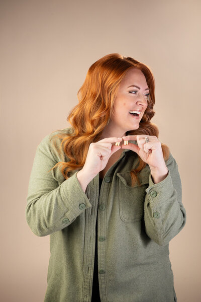 woman with red hair holding  supplement  capsules
