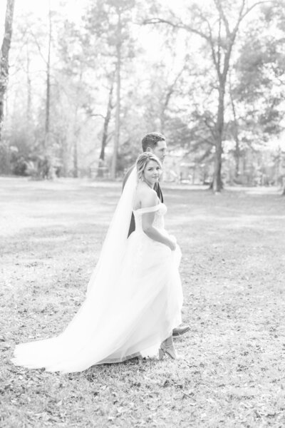 Bride and groom walk outdoors at their wedding at the Oak Atelier