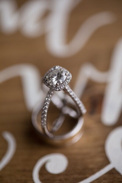 close up photo of an engagement ring sitting inside a wedding ring