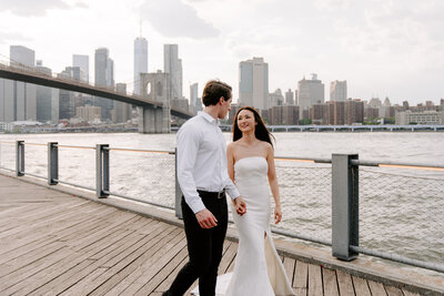 newlyweds walking down pier in brooklyn