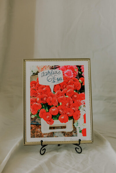fine art print of bright red dahlias at a parisian florist  on the rue cler