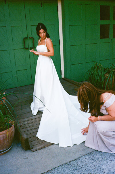 Bride's mom fixing brides dress