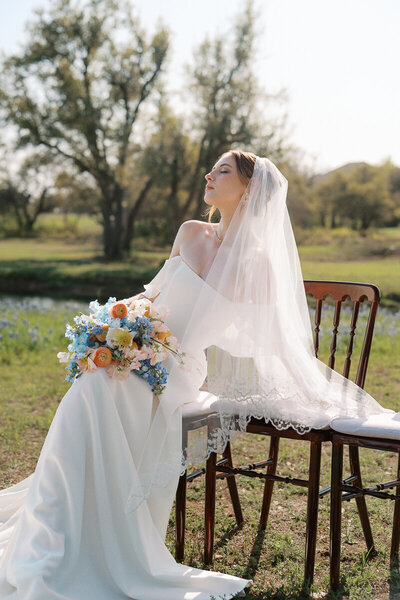 A newlywed couple relaxes in a luxurious hotel bathtub, sipping champagne after their intimate elopement at Hotel Herringbone in Waco, TX. Captured by a Waco wedding photographer.