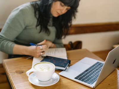 Carrie of Bloem Creations writing in a notepad, representing copywriting services she offers small biz owners and creatives. 
