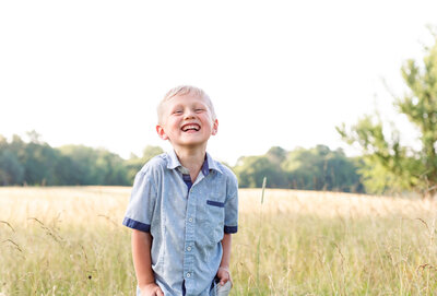 little boy laughing during summer photo session