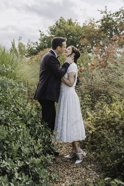 A couple kiss in the gardens of Lightfoot and Wolfville, photographed by Annapolis Valley Documentary Photographer. 