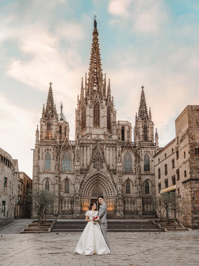 Captivating photograph of a bride and groom standing in front of a historic Spanish church, adding a touch of cultural richness to their wedding day.