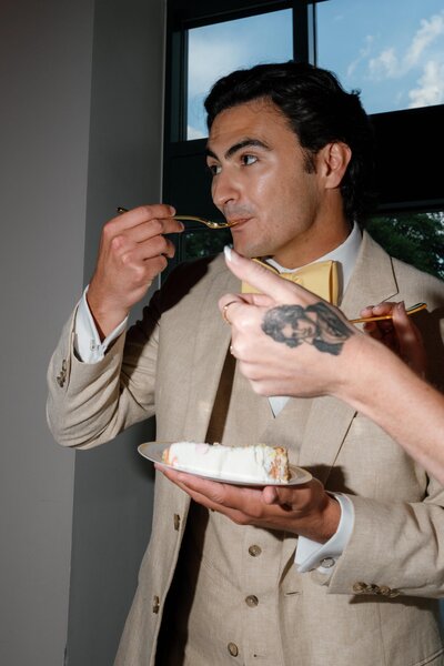 Flower girl holding an umbrella between two male guests during family portraits at a wedding in Richmond, Virginia.