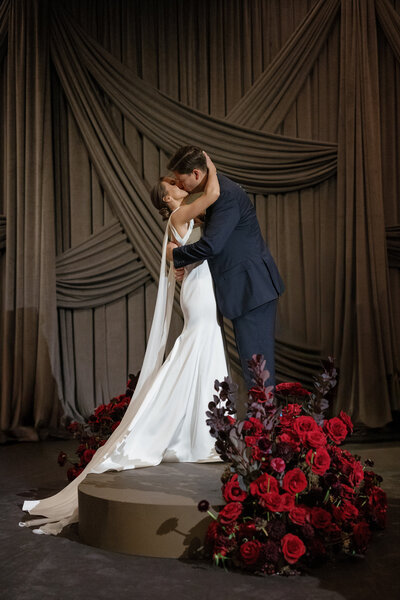 red headed bride in white Sareh Nouri bridal gown with lace bow standing on stairs