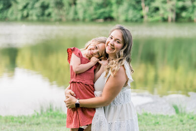 4 year old girl is happy with mom at a Lifestyle outdoor family session at Shrewsburry dean park by westborough family photographer Ivy Lulu Photography